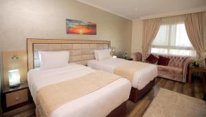 Voodi või voodid majutusasutuse Cairo Taj Hotels & Suites - Dokki toas