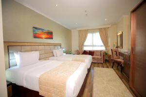 Voodi või voodid majutusasutuse Cairo Taj Hotels & Suites - Dokki toas