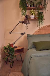 a lamp sitting on a table next to a bed at Dimora Storica a Trani con Terrazzo Jacuzzi x Dimora Storica a Trani con Terrazzo e Jacuzzi con 6 Posti Letto e Aria Condizionata in Trani +42 photos