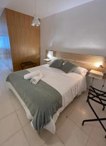 a bedroom with a large bed with two towels on it at Bamba Apartment Aracena-ONLY ADULTS in Aracena +16 photos