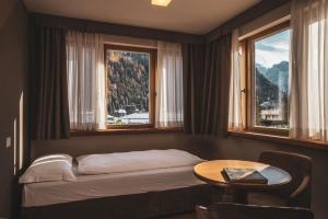 Ένα ή περισσότερα κρεβάτια σε δωμάτιο στο Hotel Crozzon
