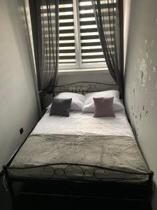 a small bed in a room with a window at Apartament na Jasnym in Dzierżoniów