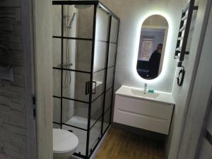 a bathroom with a sink and a toilet and a mirror at Dobry Dom I in Staszów +12 photos