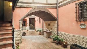 an archway of a building with plants in a courtyard at Apartamento Pozo Amargo Junto a la Catedral by Toledo AP in Toledo