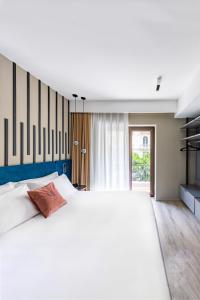 Postel nebo postele na pokoji v ubytování MH SUITES Plebiscito