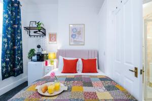 a bedroom with a bed with a tray of fruit on it at Jephsons Lodge Studio 7 - Town Centre, WiFi, Free Disney & Prime in Leamington Spa