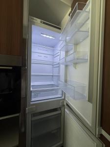 an empty refrigerator with its door open in a kitchen at Grand sapphire resort Ötüken yeni iskele North Cyprus in İskele