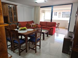 a living room with a table and a couch at Casa Ulla in Puerto Naos