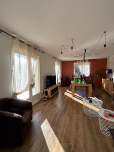 a living room with a couch and a table at Maison de la forêt in Auxonne