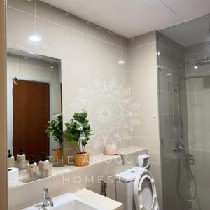 a bathroom with a shower and a sink and a mirror at The Anggun Sutera Avenue Homestay in Kota Kinabalu