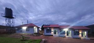 a small house with a water tower in front of it at Taurus Apartments in Chipata