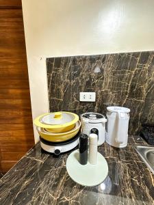 a kitchen counter with a sink and appliances on it at Stylish Studio Near Kabsat Surf Spots Urbiztondo San Juan LU in San Juan