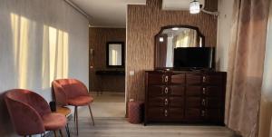 a living room with a television and a dresser with a mirror at Morii Lake Studio in Bucharest