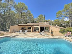 a house with a swimming pool in front of a house at Villa San Michele - 70's experience in Salernes