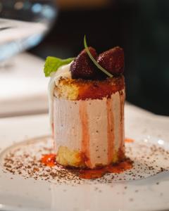 a dessert on a plate on a white plate at Locanda Gaudemus Boutique Hotel in Sistiana