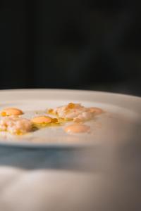 a plate of food with shrimp and eggs on it at Locanda Gaudemus Boutique Hotel in Sistiana