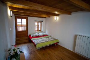 a bedroom with a bed in the corner of a room at Apartment Bernarda - Entire House in Kobarid