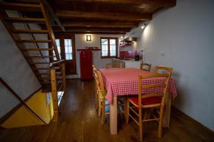 a room with a table and chairs and a kitchen at Apartment Bernarda - Entire House in Kobarid