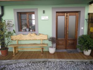 a wooden bench sitting outside of a house at Apartment Bernarda - Entire House in Kobarid