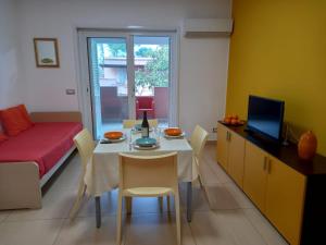 a living room with a table and chairs and a couch at Gemme di Portorosa in Furnari