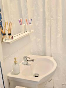 a bathroom with a sink and a shower curtain at Enjoy my Home near Palas Mall 2 in Iaşi