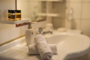 a white bathroom sink with two rolled towels on it at Mare nostrum - Alykes Zakynthou in Alykes