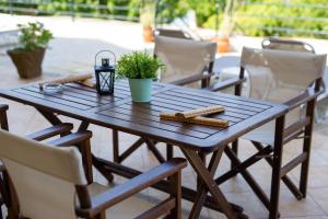a wooden table with cookies and a plant on a patio at Mare nostrum - Alykes Zakynthou in Alykes