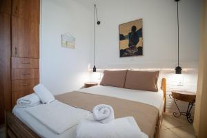a bedroom with a bed with towels on it at Mare nostrum - Alykes Zakynthou in Alykes