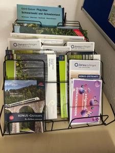 a stack of books sitting on a shelf at Apartment DS - Rebberg in Donaueschingen