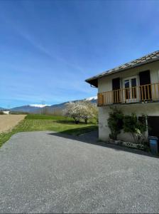 a house with a balcony and a driveway at Maison mitoyenne 60m2 en campagne in Montailleur