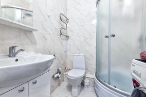a bathroom with a sink and a toilet and a shower at Уютная кв в ЖК Комсомольский in Taldykolʼ +20 photos