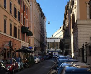 a city street with cars parked on the side of the road at Affittacamere Alex in Rome