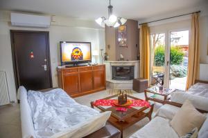 a living room with a couch and a tv at Chris Cozy Apartment in Ioannina