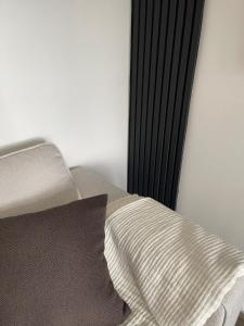 una cama con una almohada junto a una pared en Sheffield Contemporary Elegant Getaway, en Wincobank