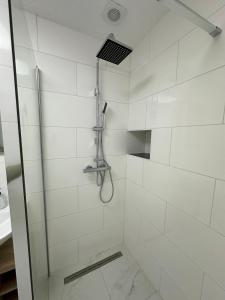 a shower with a glass door in a bathroom at Beautiful Appartment in MG - Self Check-in in Mönchengladbach