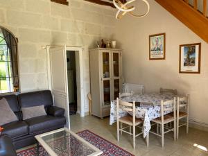a living room with a table and a couch at Loire Valley Cottages in Jarzé