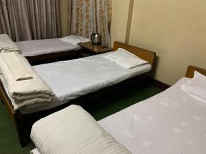 Postel nebo postele na pokoji v ubytování Hotel Sports Pvt Ltd