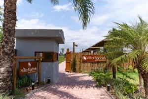 a building with a fence and a palm tree at Bahia Soul - Casa Bambu - Barra Grande - Península de Maraú in Barra Grande