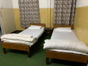 Postel nebo postele na pokoji v ubytování Hotel Sports Pvt Ltd