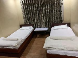 Postel nebo postele na pokoji v ubytování Hotel Sports Pvt Ltd
