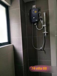 a shower in a bathroom with a blow dryer at 74 pangkorocean villa88 in Kampong Sungai Udang