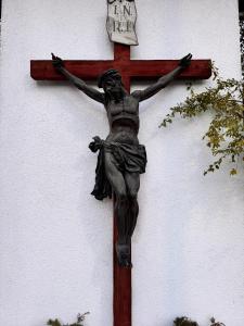 a statue of a woman on a cross at Gästehaus Johannes in Niedernsill