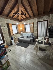 a living room with a couch and a table at Casa Escuela Trasmiras in Trasmiras