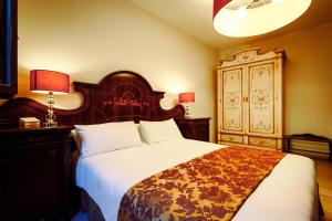 Voodi või voodid majutusasutuse Vico Regio Hotel toas
