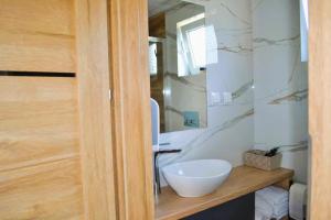 a bathroom with a white sink and a mirror at Domek na Dogalu in Filipowice +15 photos