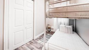a bedroom with a bunk bed and a door at Boho Haven in Plaster Rock