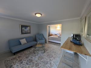 a living room with a couch and a table at Scenic Hout Bay Suite in Hout Bay