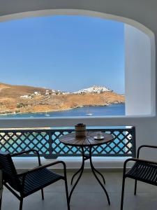 a table on a balcony with a view of the ocean at Salvia di Astypalea in Livadi Astypalaias