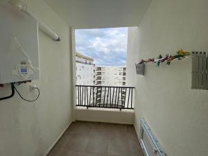 a room with a balcony with a view of a building at Beautiful Algerian style house with modern comfort in Bou Ismaïl