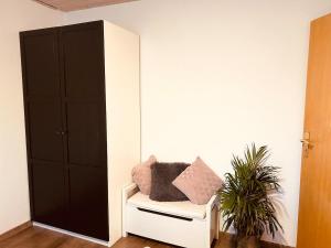 a room with a mirror and a chair with pillows at Christines Ferienwohnung in Weiler-Simmerberg